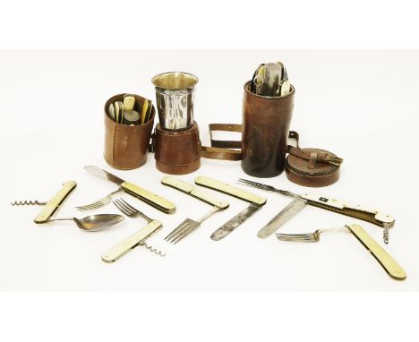 Two matched (probably) leather cased travelling cutlery sets,each with a silver plated cup, corkscrew, folding knife spoon an
