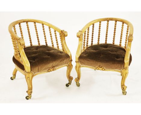 A pair of Victorian satin walnut tub chairs, with scrolled arms, bobbin turned supports, on carved cabriole legs, stamped 'J 