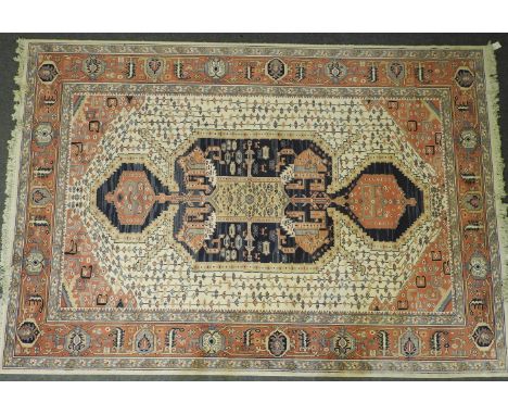 A Persian-style 'Keshan Super' carpet, the cream ground with central medallion in a foliate field within a multiple banded bo
