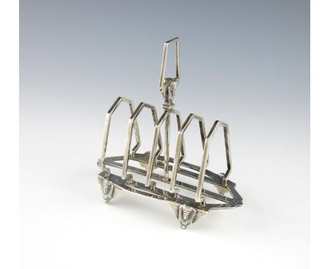 An Edwardian silver Egyptian revival toast rack, by Horace Woodward and Co, London 1902, shaped rectangular form, the central