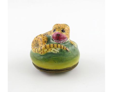 A South Staffordshire enamel bonbonniθre, late 18th century, modelled as a leopard, curled up on a grassy base with teeth bar