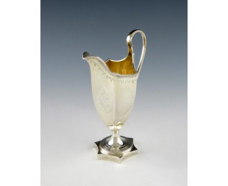 A George III silver cream jug, by Thomas Daniel, London 1786, tapering hexagonal helmet form, scroll handle, beaded borders, 