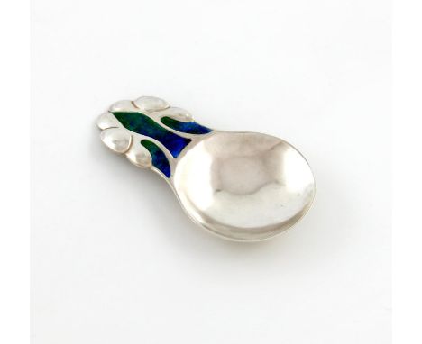 By Liberty and Co, an Edwardian Art Nouveau silver and enamel caddy spoon, Birmingham 1909, shaped circular bowl, the handle 