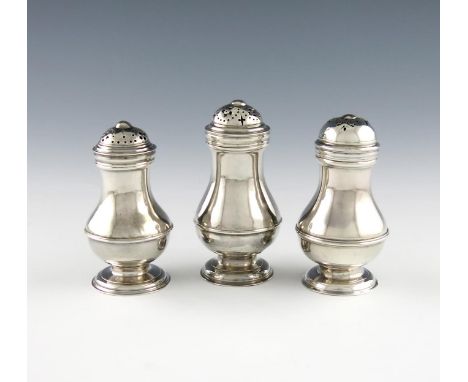 Three George II silver bun casters, one by John Gamon, date letter worn, one 1738, and one 1735, baluster form, central girdl