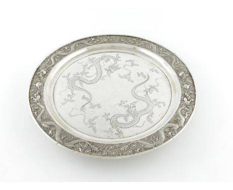 A Chinese silver salver, by Hung Chong, Canton and Shanghai, circa 1900, circular form, the centre engraved with two dragons,