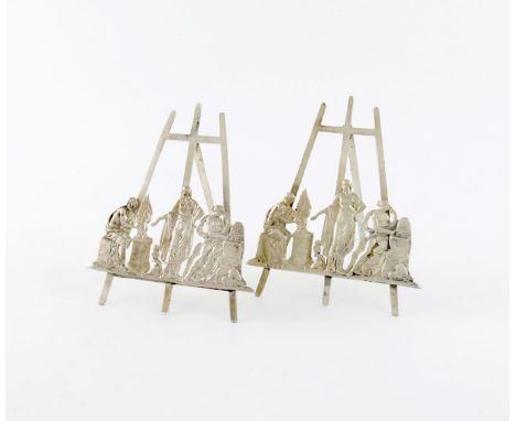 A pair of late-Victorian silver menu card holders, by S. Clifford, London 1894, easel form, mounted with three classical figu