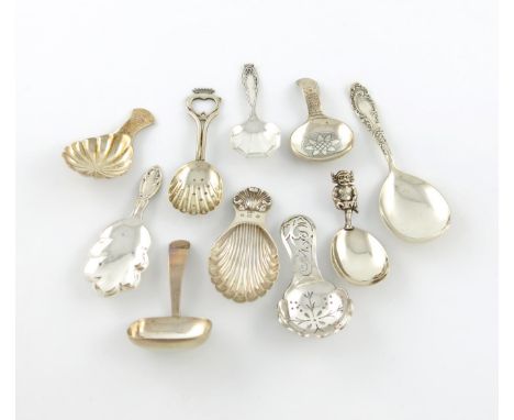 A collection of ten silver caddy spoons, comprising: one with a Lincoln Imp finial, by Thomas Holden, Birmingham 1924, one of