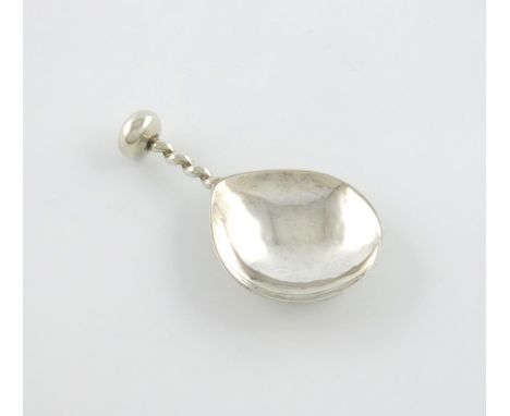 By A.E. Jones, an Arts and Crafts silver caddy spoon, Birmingham 1929, fig-shaped spot-hammered bowl, short twisted handle wi