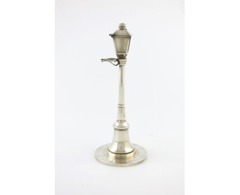 A French novelty silver table cigar lighter, retailed by Cartier, Paris, modelled as a street gas lamp, on a spread circular 