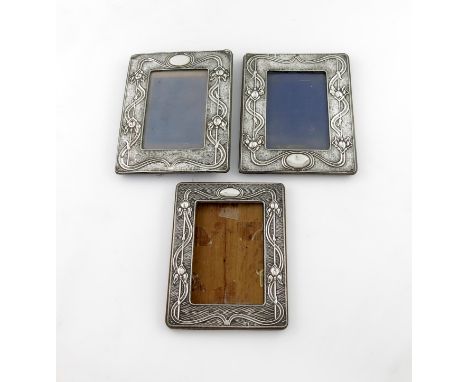 A graduated set of three Art Nouveau silver photograph frames, by A and J Zimmerman, Birmingham 1903 and 1907, comprising: a 
