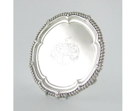 A George III silver salver, by Paul Storr, London 1814, circular form, gadroon and shell border, the centre engraved with an 