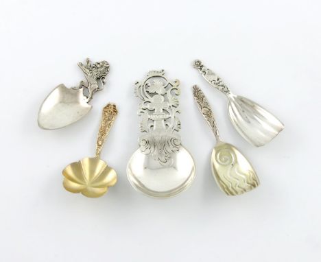 A collection of five American silver caddy spoons, comprising: one by Shreve, Crump and Low, large circular bowl, pierced and