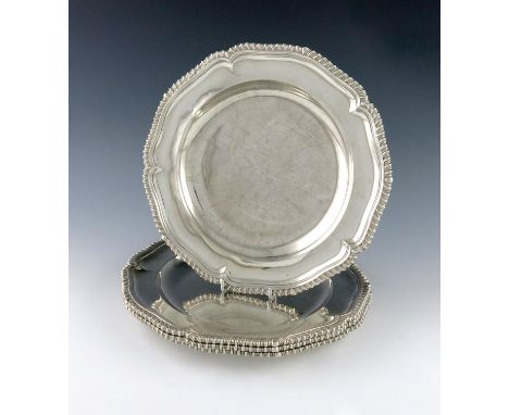 A set of four William IV silver dinner plates, by Paul Storr, London 1834, circular form, gadroon borders, the underside stam