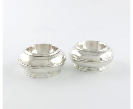A pair of Queen Anne silver salt cellars, by Matthew West, London 1706, circular cushion form, on a circular foot, engraved w
