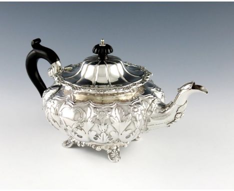 A Victorian Irish silver teapot, by Edward Power, Dublin 1838, lobed circular form, embossed foliate decoration on a matted b