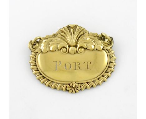 A George III silver-gilt wine label, by Paul Storr, London 1817, shaped cartouche form, with a central shell motif and gadroo