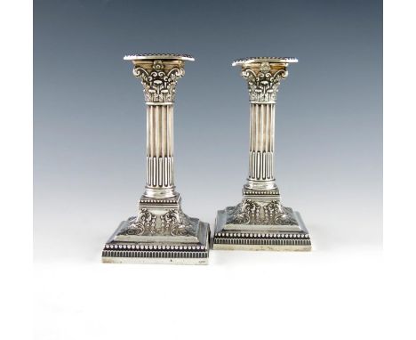 A pair of Victorian silver candlesticks, by James Dixon and Sons, Sheffield 1892, Corinthian column form, beaded borders, on 