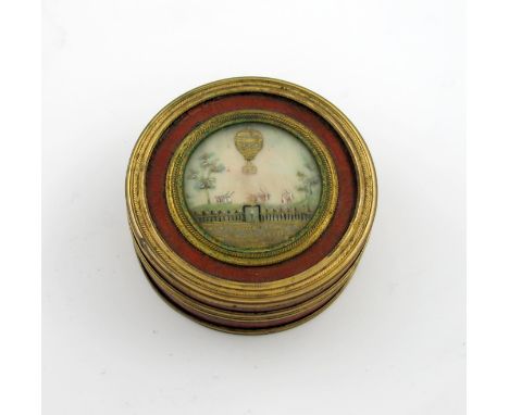 λA late-18th century French ballooning snuff box, circa 1780's, circular form, gold flecked red lacquer ground, guilt-metal b
