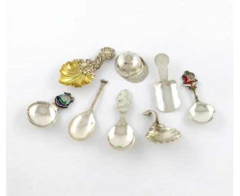 A collection of eight silver caddy spoons, comprising: a cast shell and scroll example, by I Freeman and Son, London 1944, a 