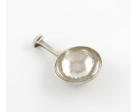 By A.E. Jones, an Arts and Crafts silver caddy spoon, Birmingham 1919, circular spot-hammered bowl, short seal-top handle wit