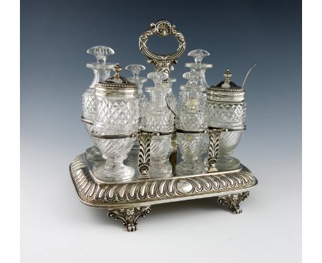 A George III silver eight bottle cruet frame, by Emes and Barnard, London 1818, rectangular form, fluted decoration, central 