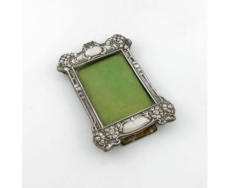 An Edwardian silver photograph frame, by Horton and Allday, Birmingham 1902, shaped rectangular form, embossed foliate decora