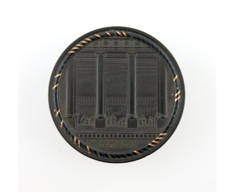 λA 19th century French gold-mounted black Bois Durci snuff box, signed DEFRANCE FECIT, circular form, the pull-of cover press