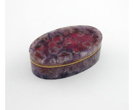 A 19th century gold-mounted amethyst snuff box, unmarked, oval form, hinged cover, the mount with a simple wavy-edge border, 
