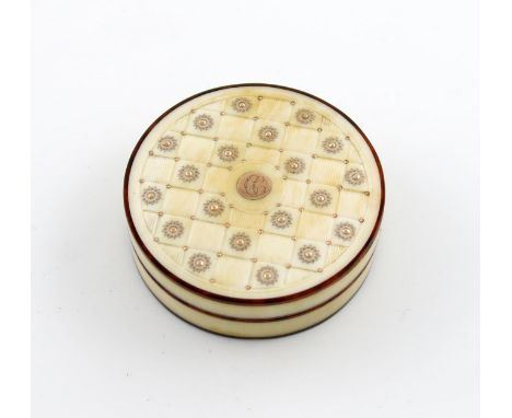 λA 19th century ivory snuff box, circular form, the pull-off cover with carved basket-weave squares with alternate panels wit