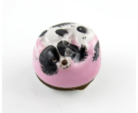 A Bilston enamel bonbonniθre, c.1770, modelled as a black and white spaniel curled up on a pink cushion, the metal-mounted an