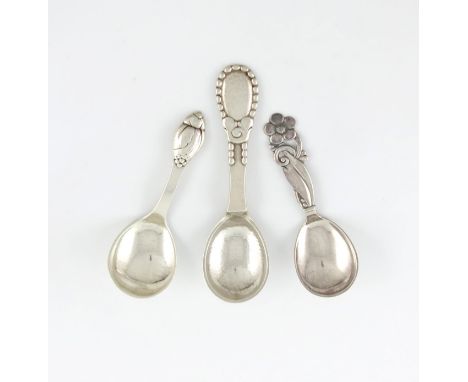 A collection of three Danish silver caddy spoons, comprising: two by Evald Nielson, Copenhagen 1926 and 1923, spot-hammered b