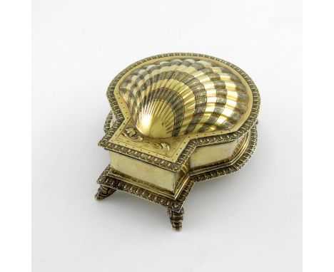 A silver-gilt inkwell, by Sebastian Garrard, London 1911, modelled as a spice box, shell form, chased decoration, the hinged 