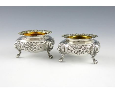 A pair of George IV silver salt cellars, by William Bateman, London 1828, heavy cauldron form, with garlands of flowers and f