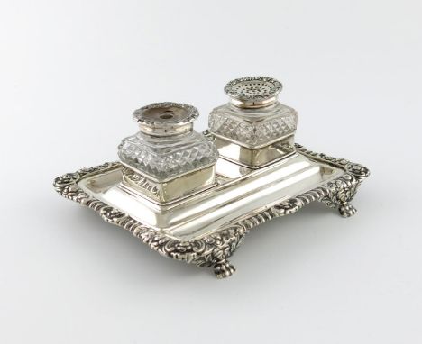 A George III silver inkstand, by Joseph Anghell, London 1819, rectangular form, gadroon and foliate shell border, with an old