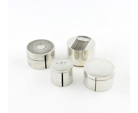 A collection of four American silver stamp roll dispensers, circular form, hinged covers, two with engine-turned decoration a
