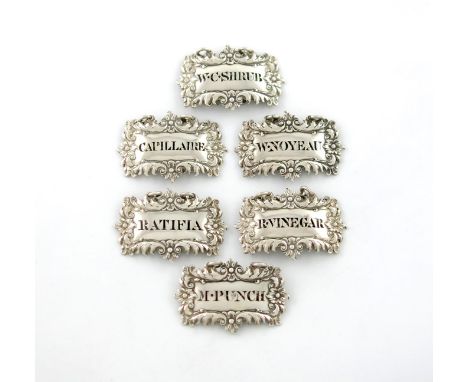 A set of six George III silver wine labels, by John Reily, London 1825, shaped broad rectangular form, foliate borders, pierc