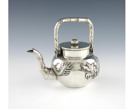 A Chinese silver teapot, by Hung Chong, Canton and Shanghai, circa 1900, circular form, embossed with a dragon, simulated bam