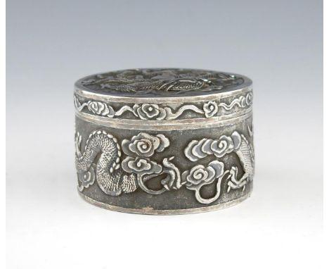 A Chinese silver dressing table box, by Wang Hing, circular form, the side and cover embossed with dragons, on a matted backg