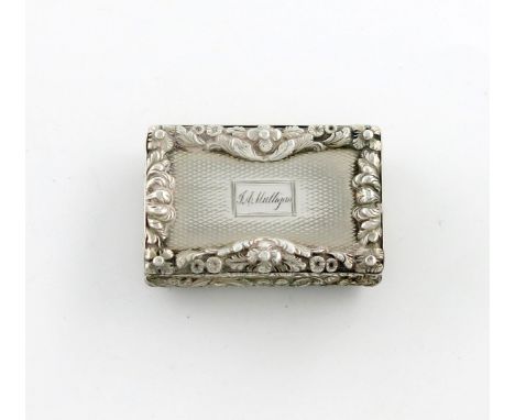 A William IV silver vinaigrette, by Nathaniel Mills, Birmingham 1836, rectangular form, embossed foliate scroll cushion sides