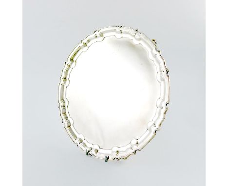 A silver salver, by William Hutton and Sons, Sheffield 1916, circular form, moulded border, on three gnarl feet, length 30.2c