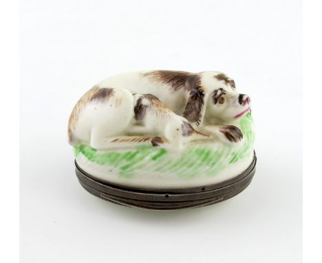 A Mennecy silver-mounted snuff box, c.1750, the mount with a later Dutch tax mark, modelled as a dog and her puppy recumbent 