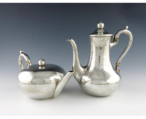 λA Victorian silver teapot and coffee pot, by D and C Houle, London 1863, circular form, engraved trellis decoration, scroll 