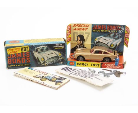 A Corgi Toys 261 James Bond's Aston Martin D.B.5, gold body, red interior, wire wheels, Bandit figure, in original box with i