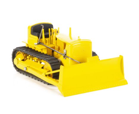 A 1950s Reuhl Products 1:24 Caterpillar D7 Bulldozer, scarce model, yellow diecast body and operational blade, plastic engine