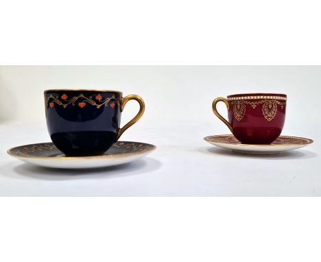 Two Royal Worcester demi-tasse and saucers, printed puce marks, date codes for 1929, the first claret ground example gilt wit