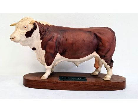 Beswick tinted bisque porcelain 'Connoisseur' model of a Hereford bull, on polished wooden plinth base, 30cm wide overall 