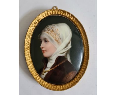 Probably early 20th century miniature portrait on porcelain of lady with white headscarf, brown jacket and wearing cross, set