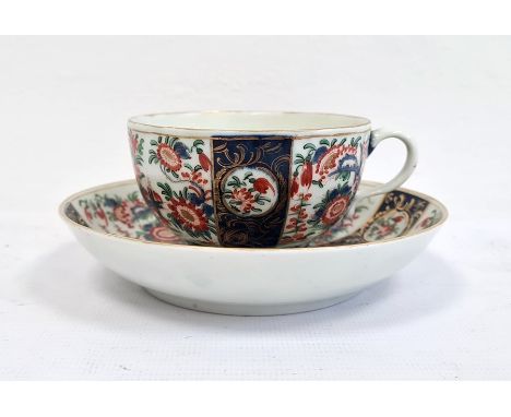 Worcester teacup and saucer, 1760-1770, blue fret marks and iron-red chinoiserie-style monogram, painted in the Imari palette