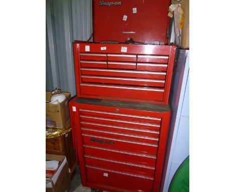 Red Snap-On tool chest with cabinet over six small drawers and three longer drawers, on top of larger Snap-On lockable tool c