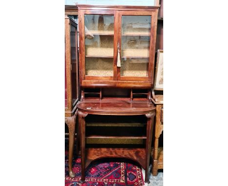 Early 20th century mahogany cabinet with two glazed doors enclosing shelves, above pigeonholes, desk top and kneehole shelf, 